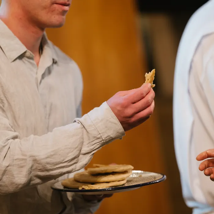 Bread is passed hand to hand during the service