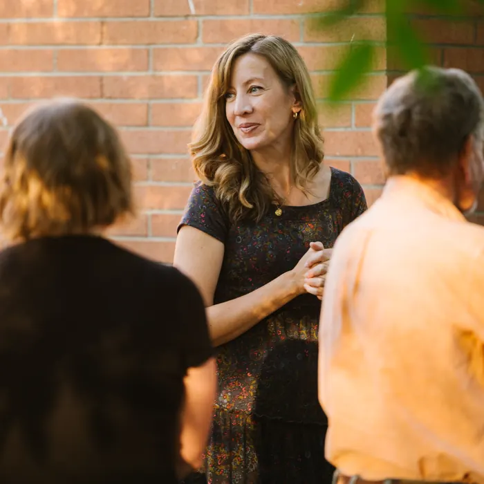 Friends talk outside the church building after worship